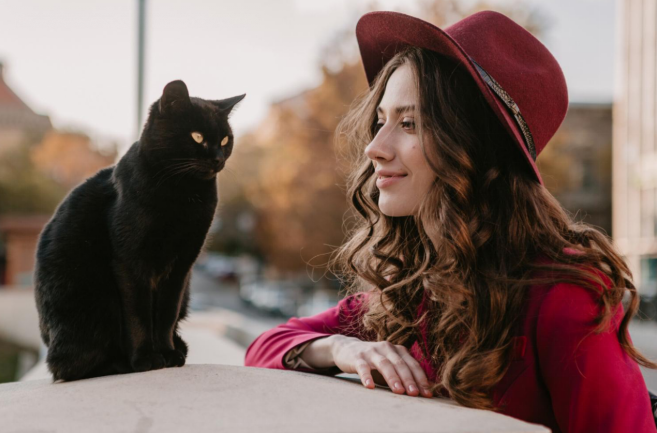 cat sitting besides a girl